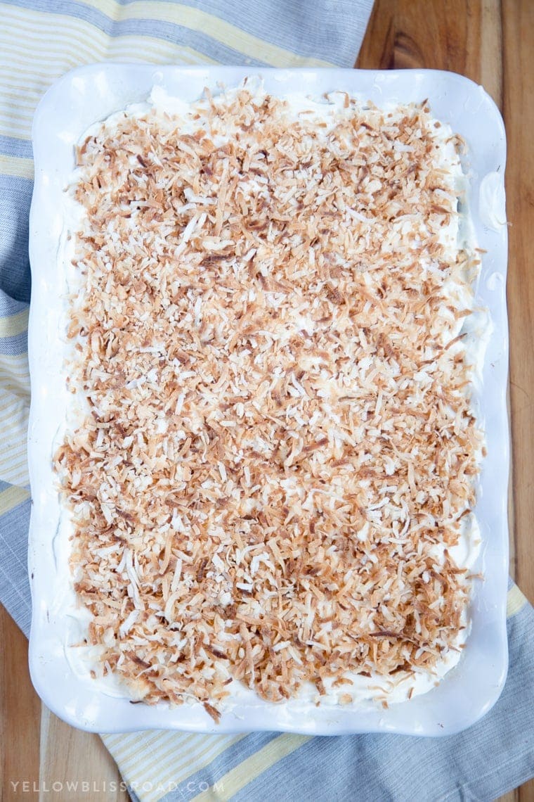 Chocolate Coconut Cream Poke Cake - Rich chocolate cake, coconut cream filling and fluffy, creamy frosting. A rich and decadent dessert!