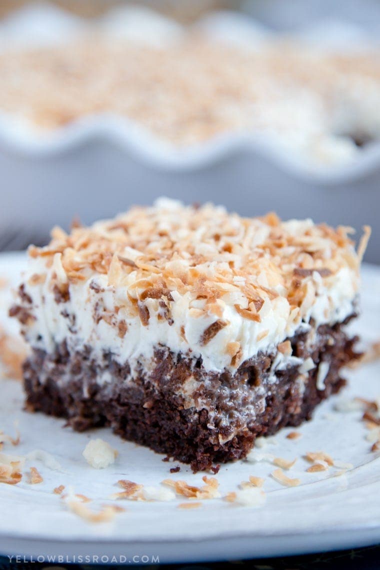 Chocolate Coconut Cream Poke Cake - Rich chocolate cake, coconut cream filling and fluffy, creamy frosting. A rich and decadent dessert!