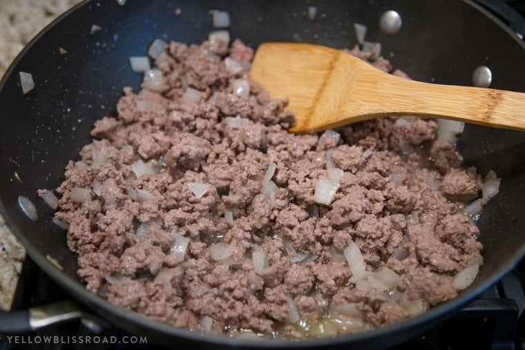 Ground beef and onions cooking in a skillet