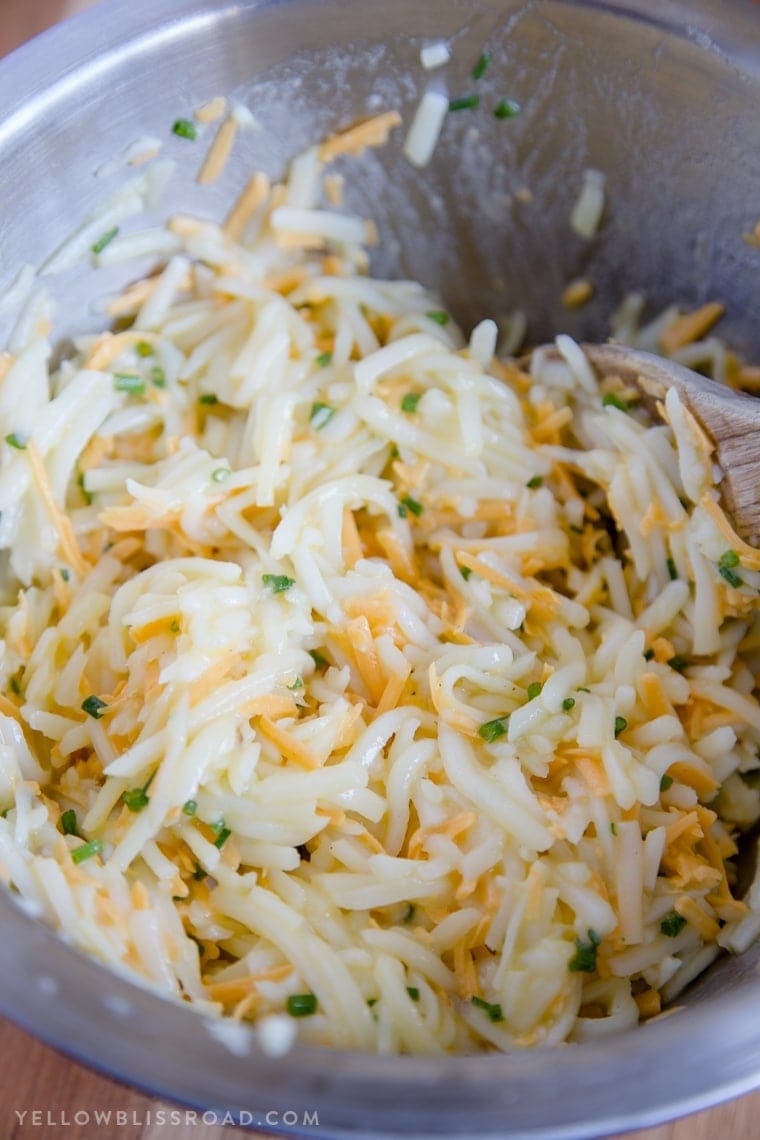 Shredded potatoes, eggs, cheese and chives mixed together for Egg & Cheese Hash Brown Waffles.