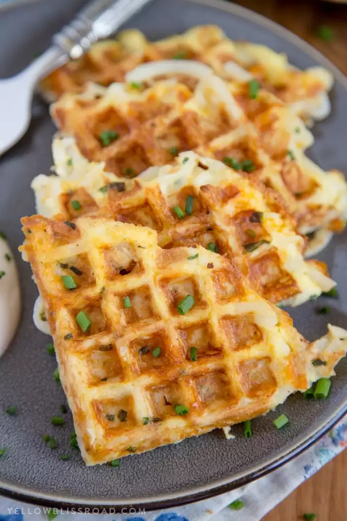 Egg & Cheese Hash Brown Waffle cut into triangles on a plate