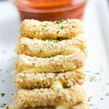 A close up of baked mozzarella sticks