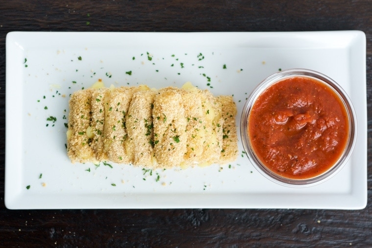 Baked Mozzarella Sticks- Easy, quick and healthier too! Enjoy these baked mozzarella sticks for any occasion or party.