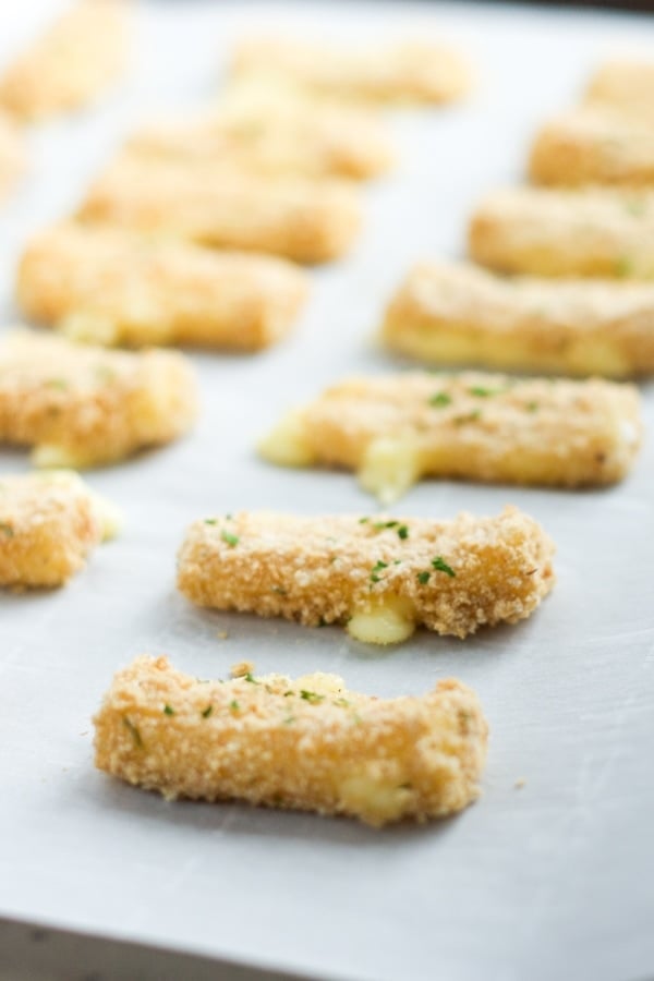 Baked Mozzarella Sticks- Easy, quick and healthier too! Enjoy these baked mozzarella sticks for any occasion or party.