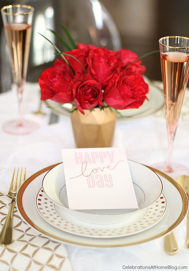 A decorated table with red roses