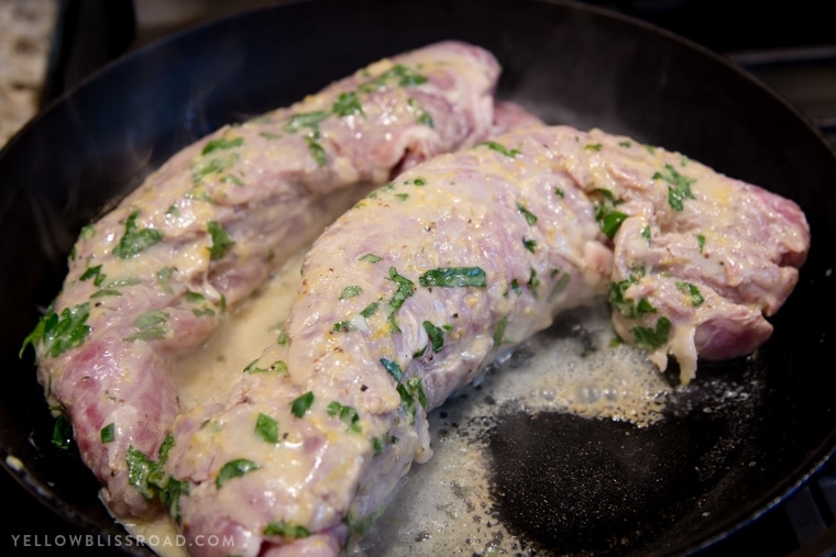 A close up of a Pork Tenderloin in a pan