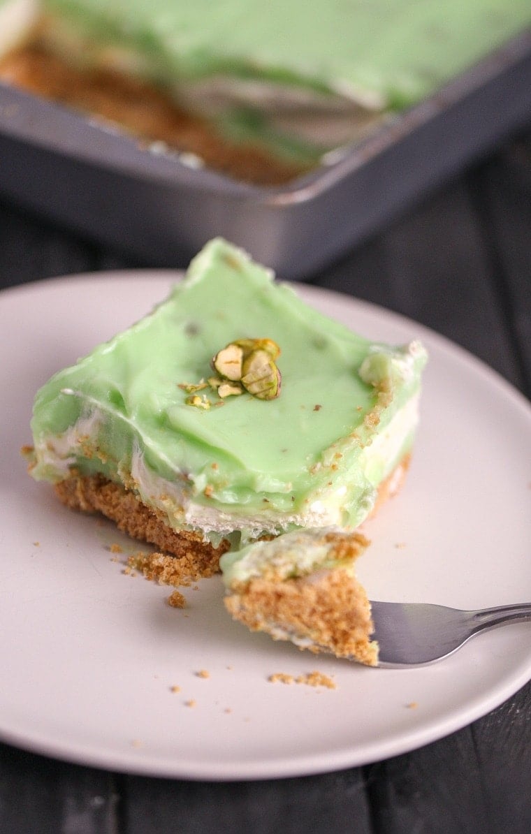 An easy Pistachio Icebox Cake that is layers of goodness. The cake is made with graham crackers, pistachio pudding and lots of whipped topping!