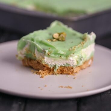 An easy Pistachio Icebox Cake that is layers of goodness. The cake is made with graham crackers, pistachio pudding and lots of whipped topping!