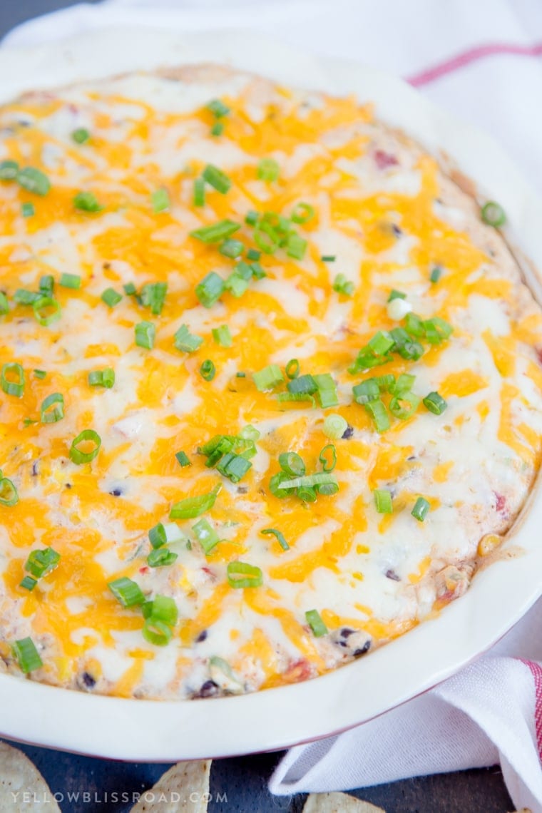 Creamy Cheesy Southwest Dip - a delicious appetizer with lots of spicy cheeses, black beans, corn and spicy tomatoes.