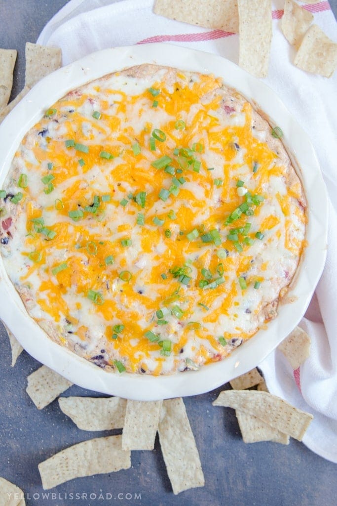 Creamy Cheesy Southwest Dip - a delicious appetizer with lots of spicy cheeses, black beans, corn and spicy tomatoes.