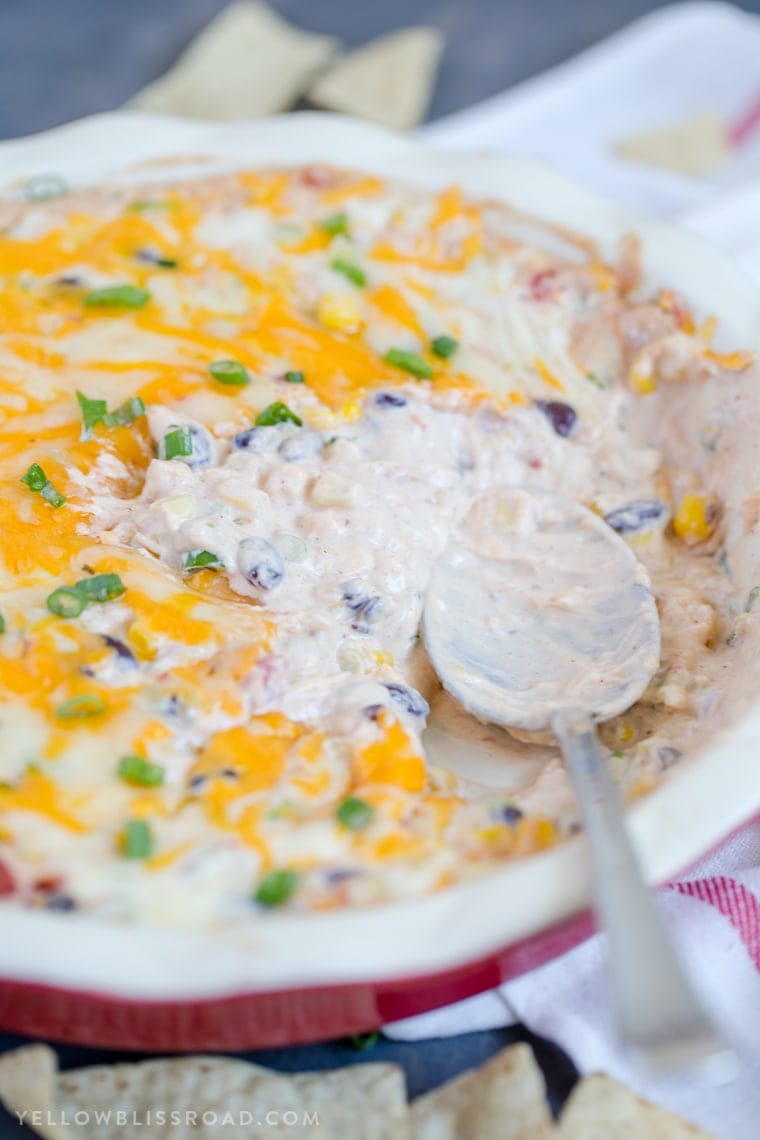 Creamy Cheesy Southwest Dip - a delicious appetizer with lots of spicy cheeses, black beans, corn and spicy tomatoes.