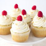Coconut Cupcakes with a Raspberry Filling - coconut flavored cupcakes filled with a fresh raspberry filling and topped with a delicious coconut frosting and toasted coconut.