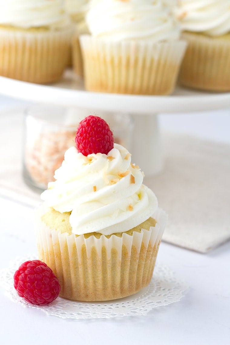 Coconut Cupcakes with a Raspberry Filling - coconut flavored cupcakes filled with a fresh raspberry filling and topped with a delicious coconut frosting and toasted coconut.