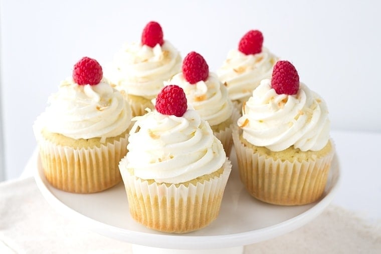 Coconut Cupcakes with a Raspberry Filling - coconut flavored cupcakes filled with a fresh raspberry filling and topped with a delicious coconut frosting and toasted coconut.