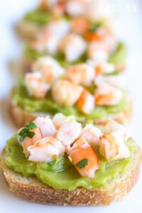 Guacamole Shrimp Bruschetta is an easy, 10-minute appetizer that's full of flavor and perfect for parties!