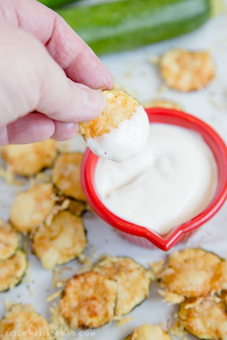 a zucchini chip dipped in ranch dressing