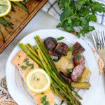 A plate of salmon, potatoes and asparagus on a table