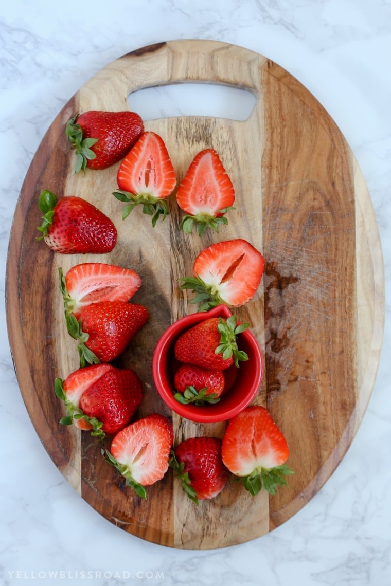 This Strawberries and Cream Poke Cake takes full advantage of Strawberry season with tons of fresh strawberries in the filling and the frosting. It's a strawberry lovers dream dessert!