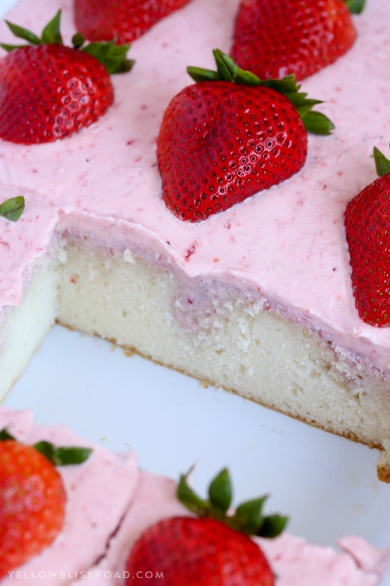 This Strawberries and Cream Poke Cake takes full advantage of Strawberry season with tons of fresh strawberries in the filling and the frosting. It's a strawberry lovers dream dessert!