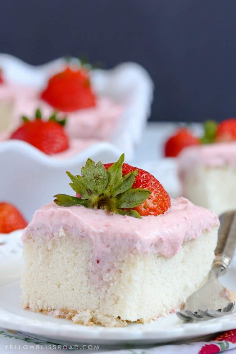 This Strawberries and Cream Poke Cake takes full advantage of Strawberry season with tons of fresh strawberries in the filling and the frosting. It's a strawberry lovers dream dessert!