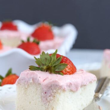 A close up of a piece of strawberry cake on a plate