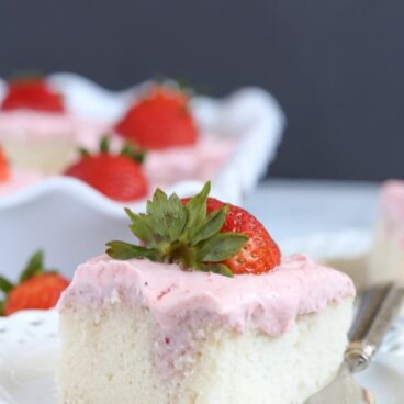 A close up of a piece of strawberry cake on a plate