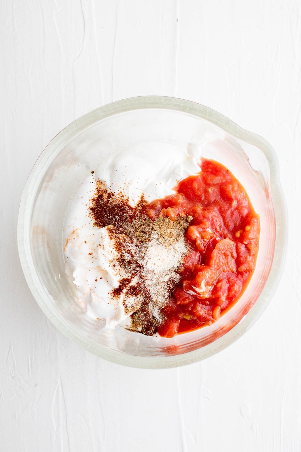 Small bowl with sour cream, mayo salsa and seasonings.