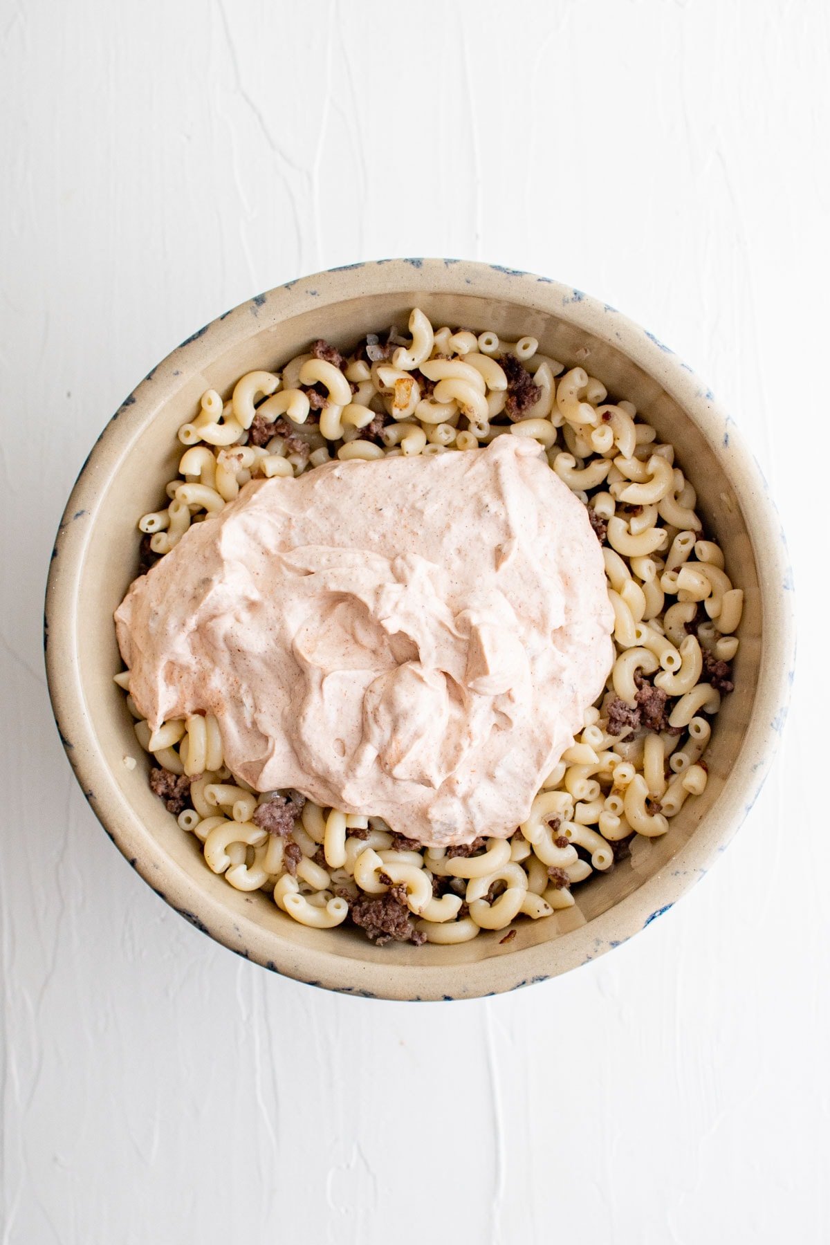 Macaroni, cooked ground beef, creamy taco salad dressing.