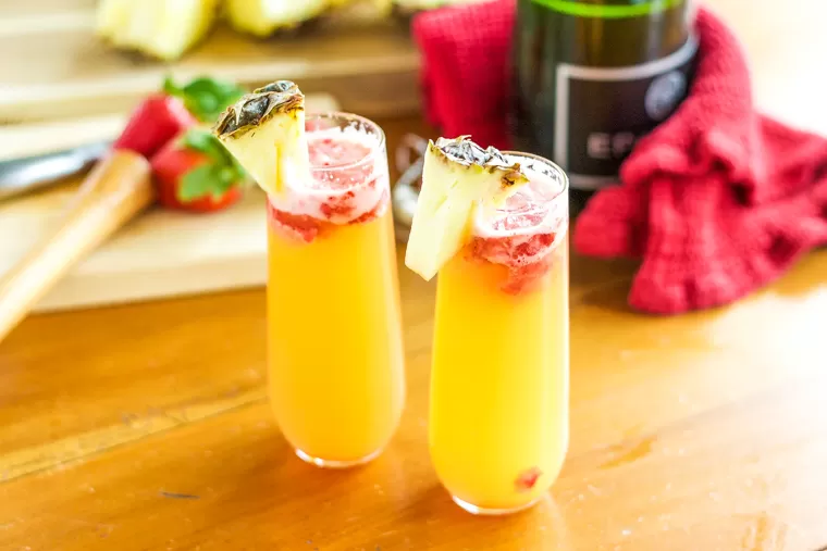 This Pineapple Strawberry Mimosa is crisp and refreshing and perfect for brunch! It's a stand-by classic with a sweet, fun twist.