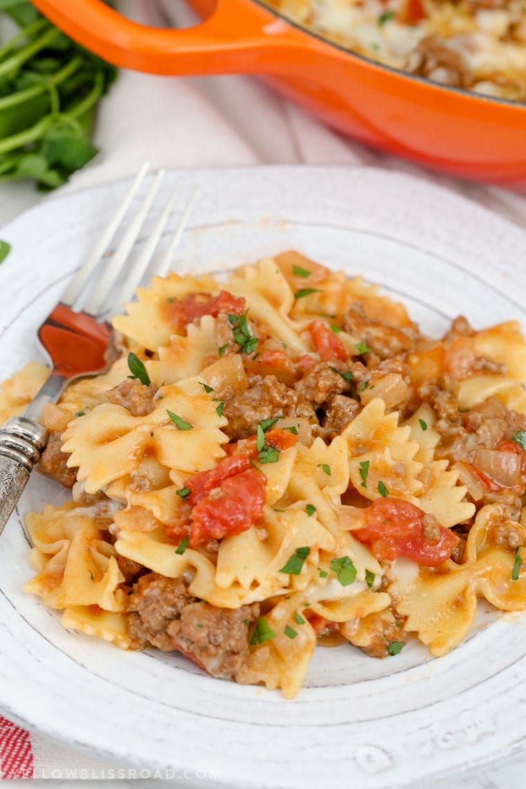 This Cheesy Beef & Tomato Pasta Skillet is sure to become your new favorite meal. All cooked in one pan, this easy weeknight dinner comes together in less than 30 minutes!