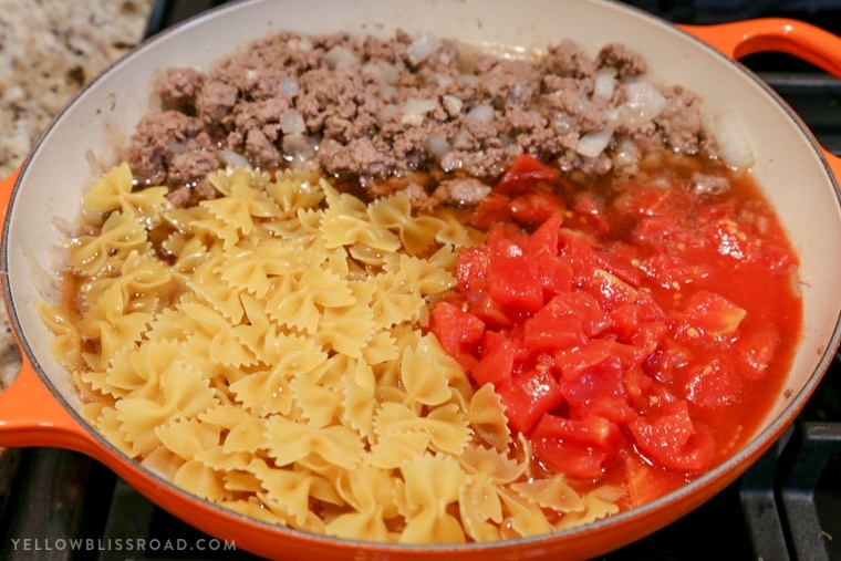 This Cheesy Beef & Tomato Pasta Skillet is sure to become your new favorite meal. All cooked in one pan, this easy weeknight dinner comes together in less than 30 minutes!