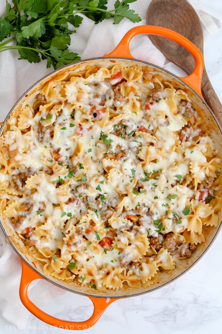 This Cheesy Beef & Tomato Pasta Skillet is sure to become your new favorite meal. All cooked in one pan, this easy weeknight dinner comes together in less than 30 minutes!