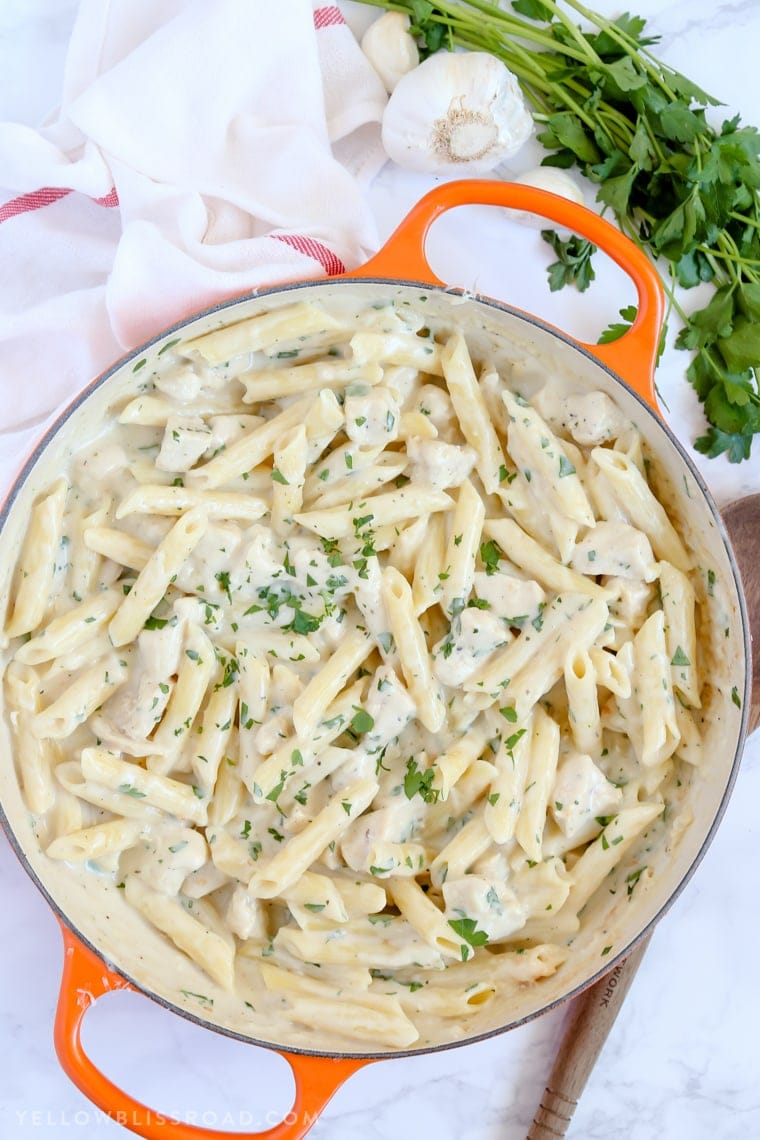 A large skillet full of Creamy Garlic Penne Pasta with Chicken.