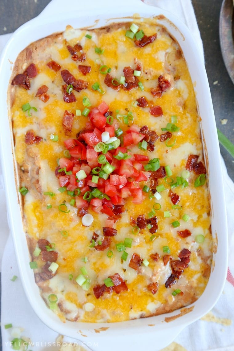 Cheddar Bacon Ranch Bean Dip topped with tomatoes and green onions