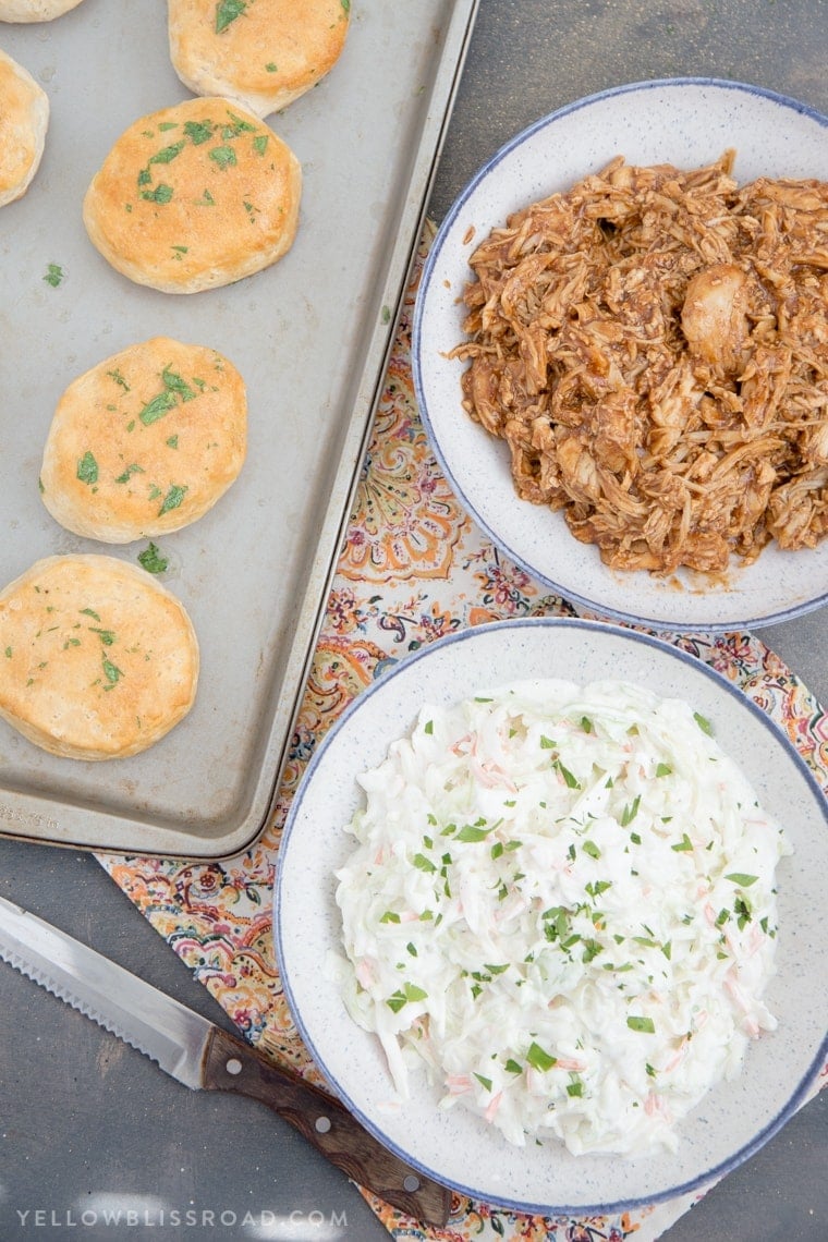 Barbecue Chicken Biscuit Sandwiches - Tender, flaky biscuits brushed with garlic butter and filled with tender BBQ chicken and a creamy, tangy coleslaw. 