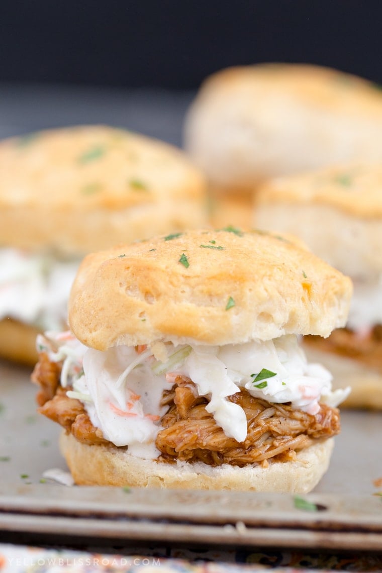 Barbecue Chicken Biscuit Sandwiches - Tender, flaky biscuits brushed with garlic butter and filled with tender BBQ chicken and a creamy, tangy coleslaw. 