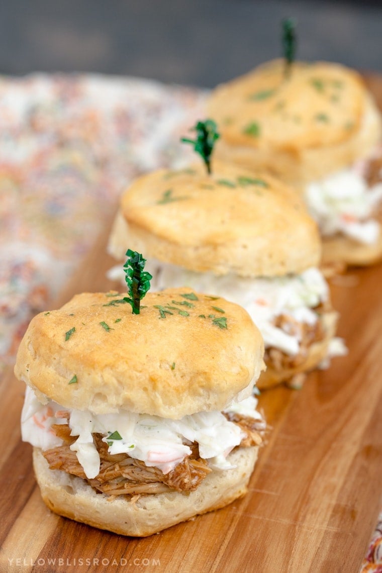 Barbecue Chicken Biscuit Sandwiches - Tender, flaky biscuits brushed with garlic butter and filled with tender BBQ chicken and a creamy, tangy coleslaw. 