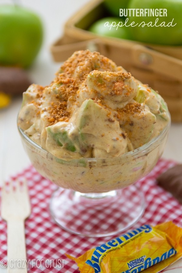 A bowl of apple salad sitting on top of a table