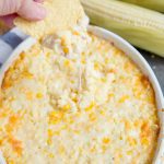A close up of corn dip with chip