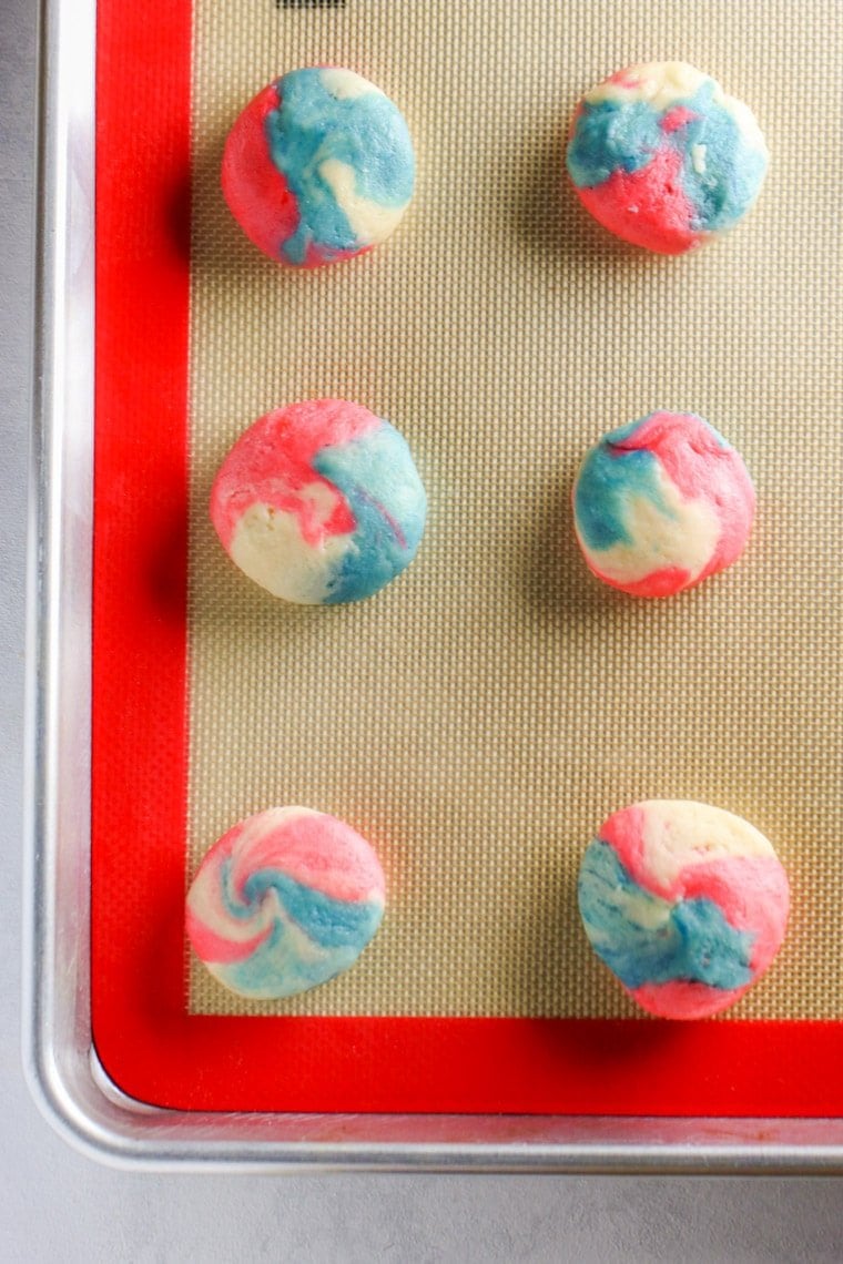 These Patriotic Cheesecake Cookies are an adorable version of our classic cookie. Created in a swirl of red, white and blue, they are the perfect dessert for Fourth of July!