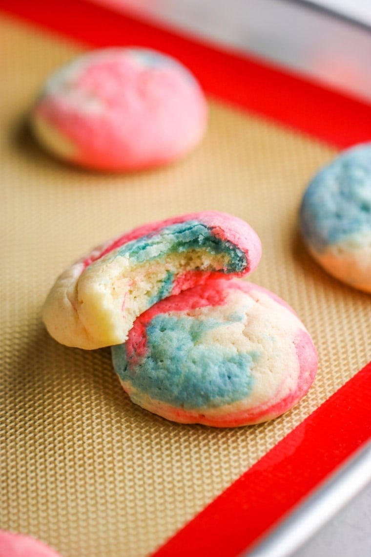 These Patriotic Cheesecake Cookies are an adorable version of our classic cookie. Created in a swirl of red, white and blue, they are the perfect dessert for Fourth of July!