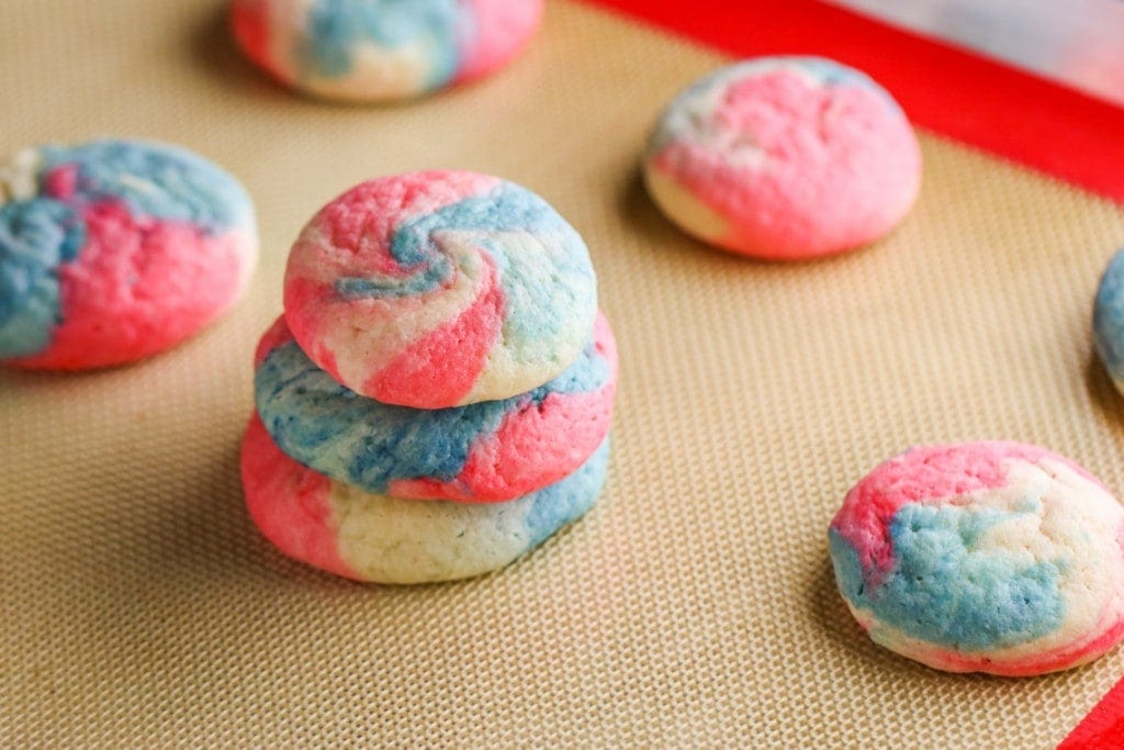 These Patriotic Cheesecake Cookies are an adorable version of our classic cookie. Created in a swirl of red, white and blue, they are the perfect dessert for Fourth of July!