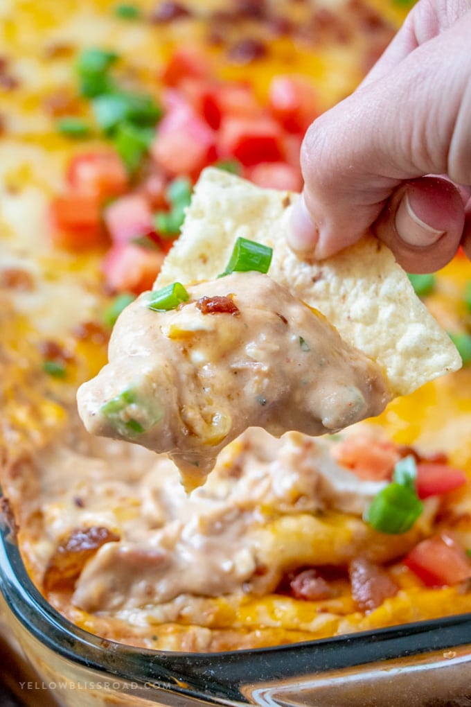 A scoop of Refried Bean dip on a tortilla chip