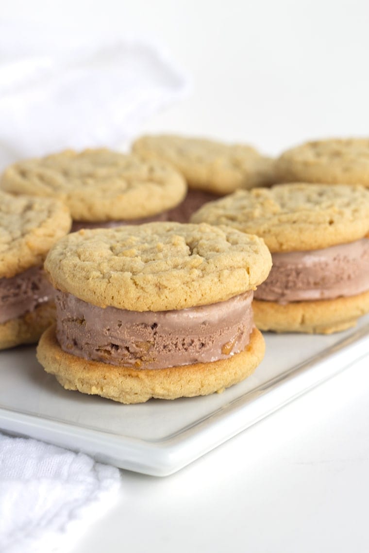 Peanut Butter Cookie and Chocolate Ice Cream Sandwiches are perfectly chewy homemade peanut butter cookies stuffed full of chocolate peanut butter ice cream.