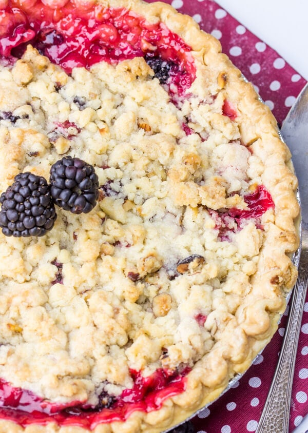 A pie with blackberries on top