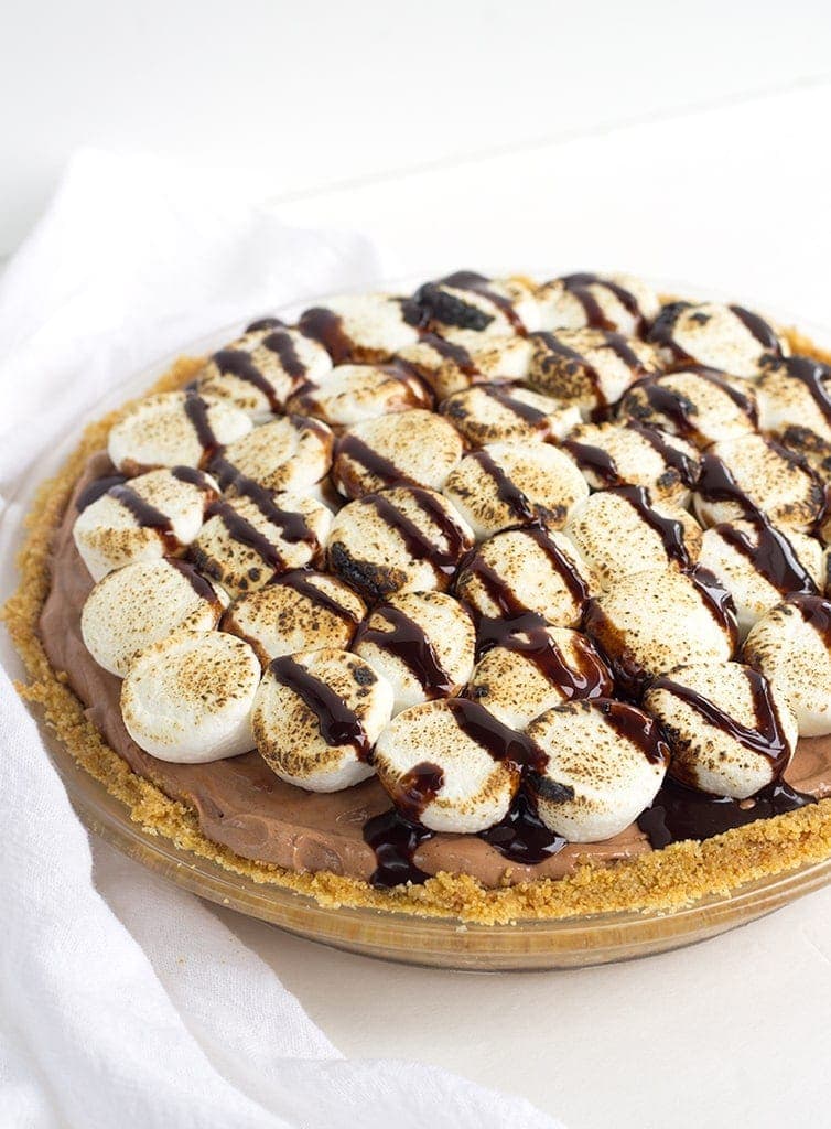 This No Bake S'Mores Pie is creamy and sweet with toasted marshmallows, chocolate, and a graham cracker crust - a cool summer dessert for those hot months!