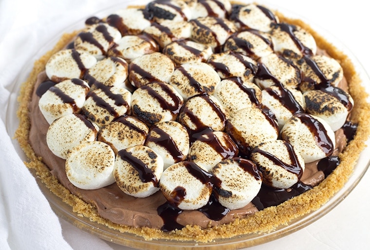 This No Bake S'Mores Pie is creamy and sweet with toasted marshmallows, chocolate, and a graham cracker crust - a cool summer dessert for those hot months!