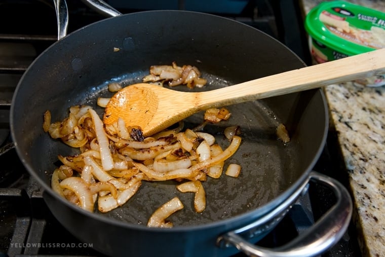 A pan sauteing onions