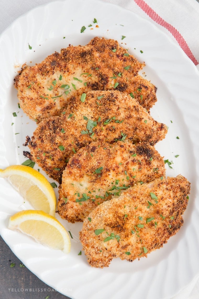 An overhead shot of Crispy Garlic Parmesan Baked Chicken on a large white platter.