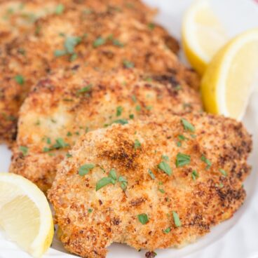 A plate of crispy parmesan baked chicken breasts